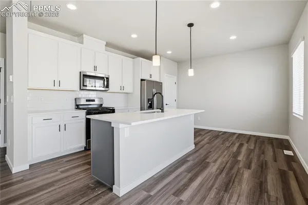 a view of a kitchen with electric appliances