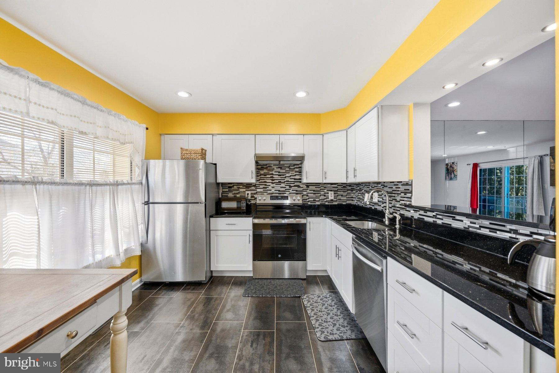 58 Hardwood Drive Rosedale, MD 21237 - Photo 5 of 38 Bright and modern kitchen with sleek finishes.