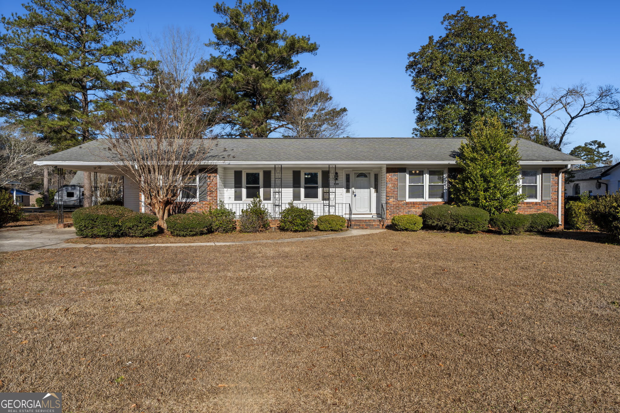 1729 Milton Way Perry, GA 31069 - Photo 1 of 41 a front view of a house with a garden and plants