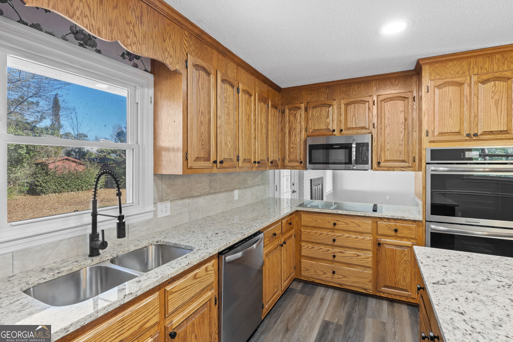 1729 Milton Way Perry, GA 31069 - Photo 13 of 41 a kitchen with stainless steel appliances wooden cabinets a sink and a stove