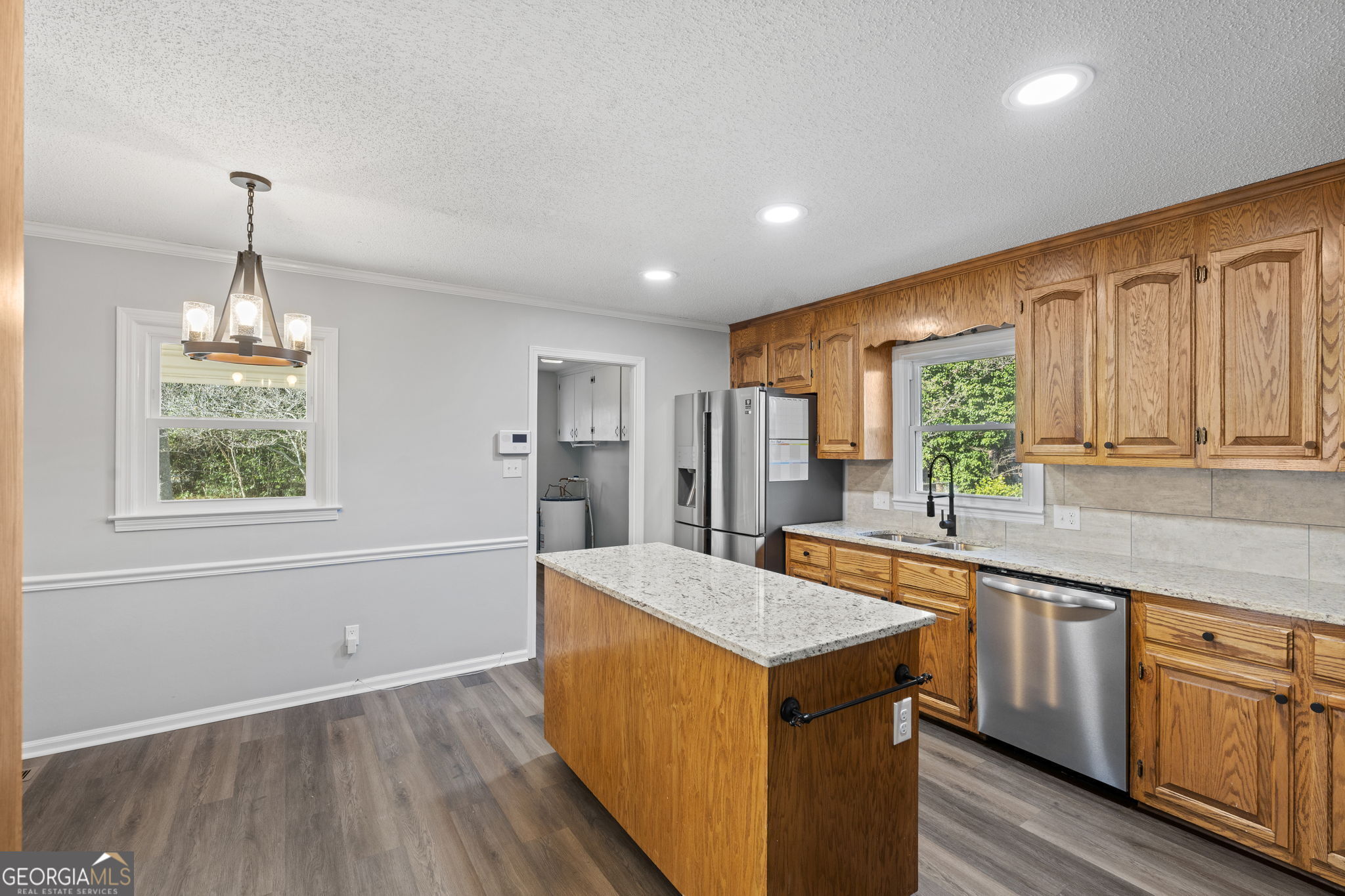 1729 Milton Way Perry, GA 31069 - Photo 15 of 41 a kitchen with stainless steel appliances granite countertop a sink a stove and a wooden floors
