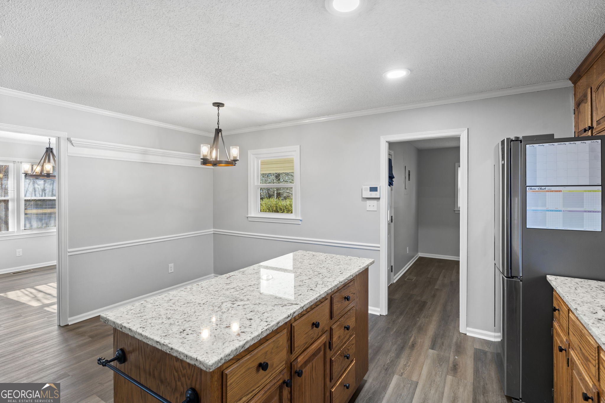 1729 Milton Way Perry, GA 31069 - Photo 17 of 41 wooden floor with chandelier and glass door