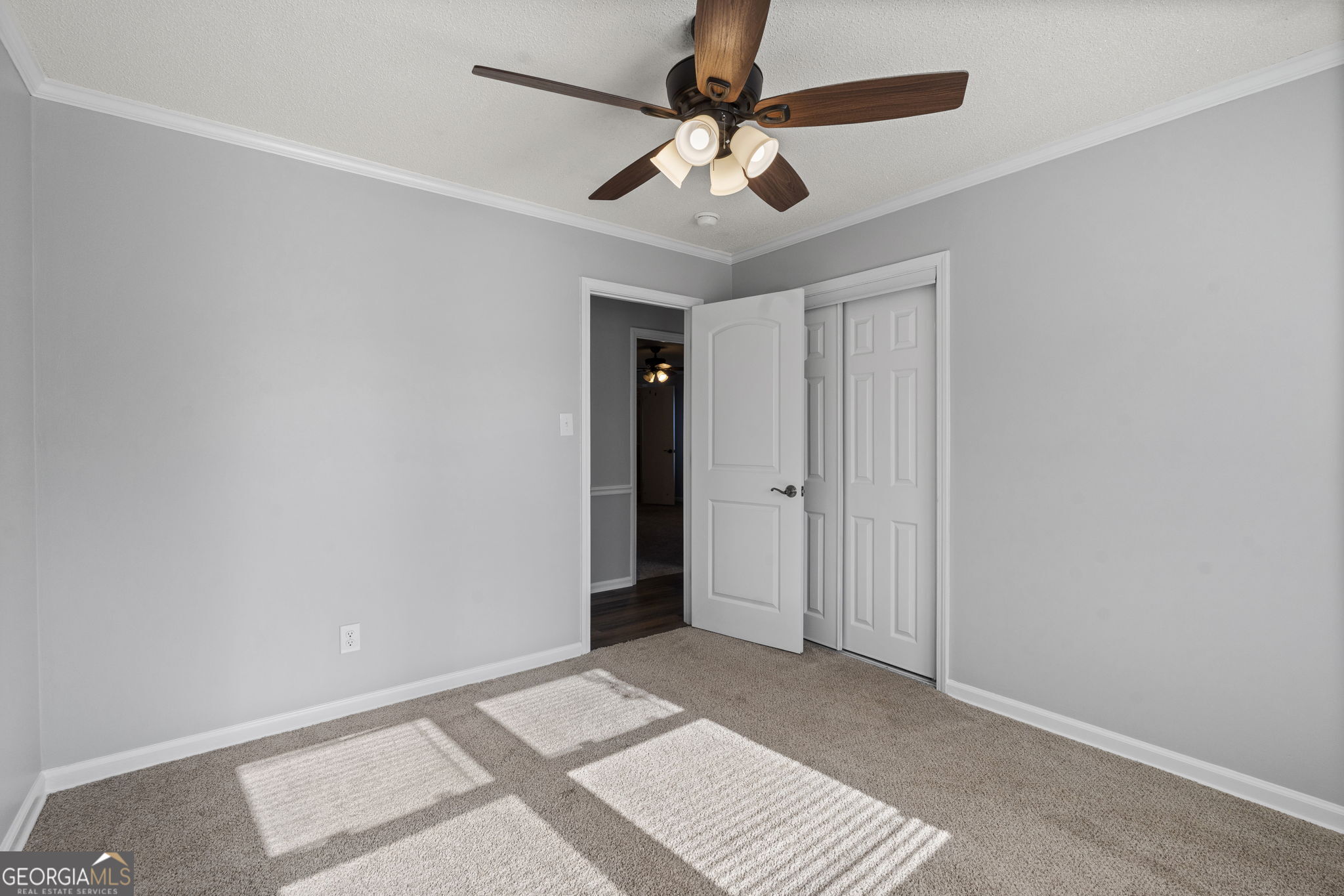 1729 Milton Way Perry, GA 31069 - Photo 27 of 41 an empty room with a ceiling fan and carpet