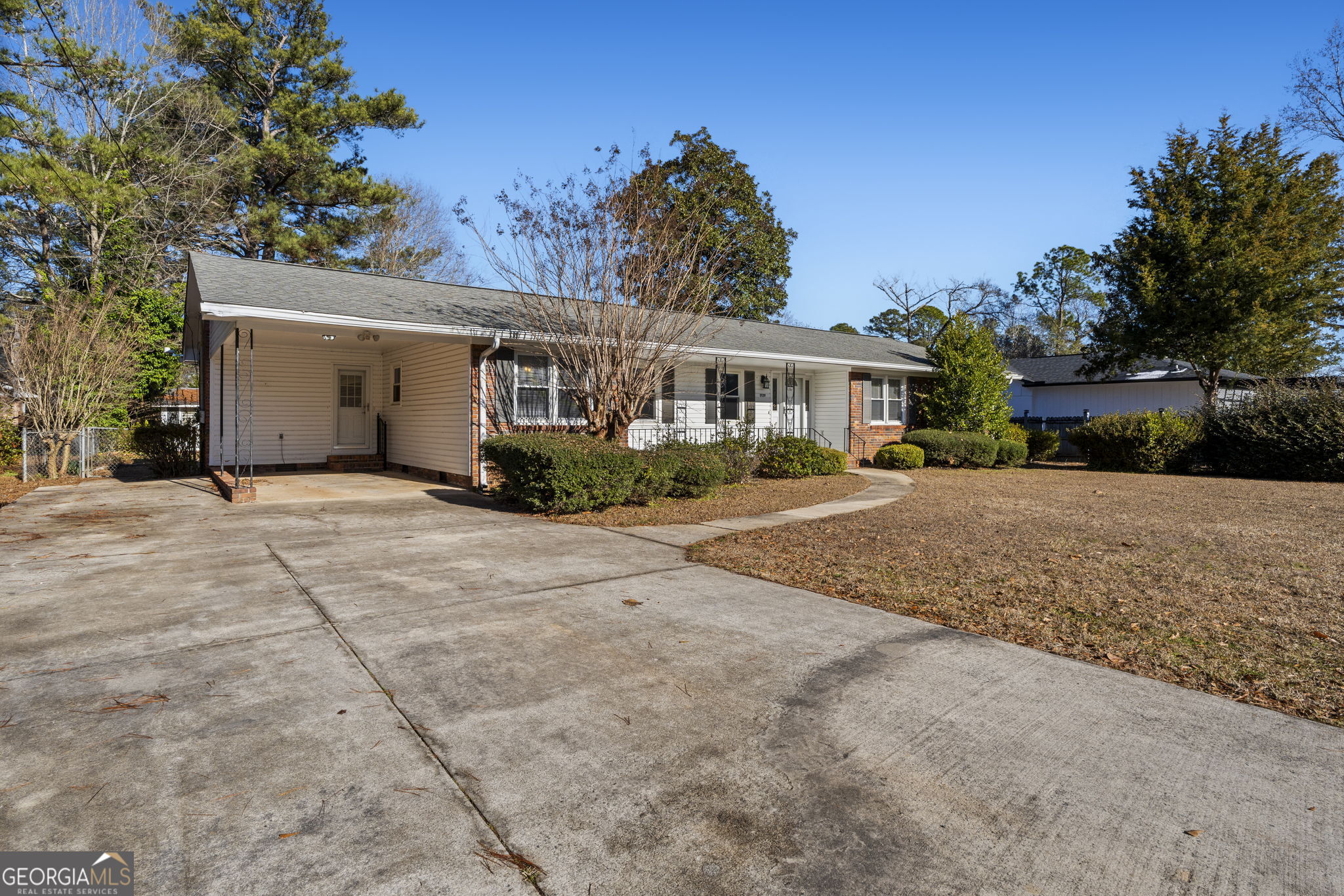 1729 Milton Way Perry, GA 31069 - Photo 3 of 41 a front view of a house with a yard and potted plants
