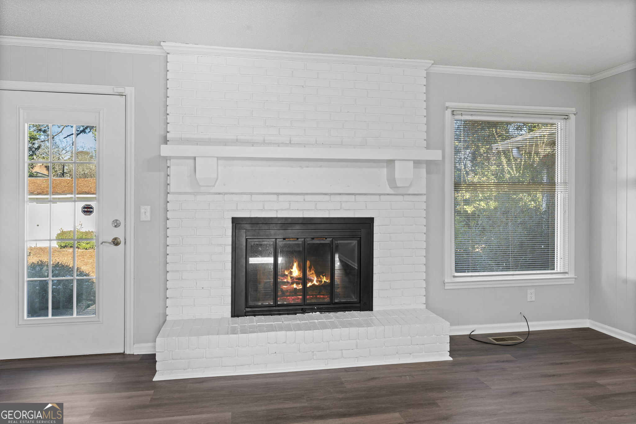 1729 Milton Way Perry, GA 31069 - Photo 10 of 41 a living room with a fireplace and a window