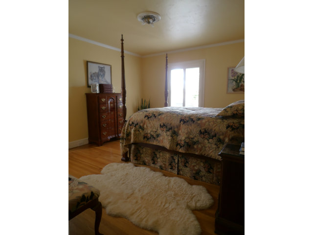 209 Channing Road Burlingame, CA 94010 - Photo 8 of 25 a bed sitting in a spacious bedroom next to a window