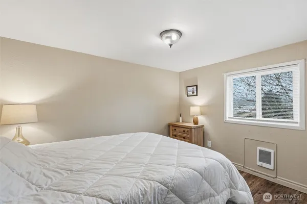 a bedroom with a bed and a lamp