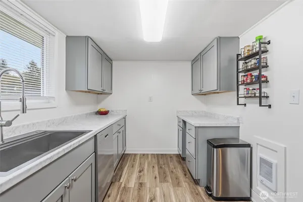 a kitchen with a sink stove and cabinets
