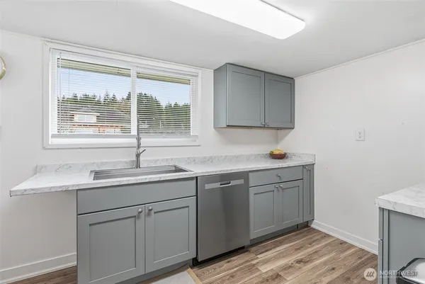 a kitchen with a sink cabinets and window