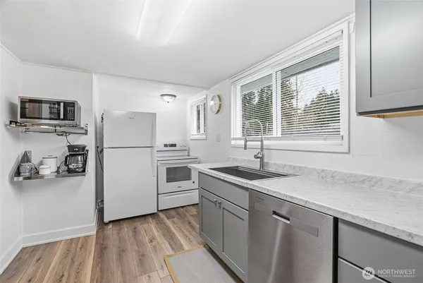 a kitchen with a refrigerator and a sink