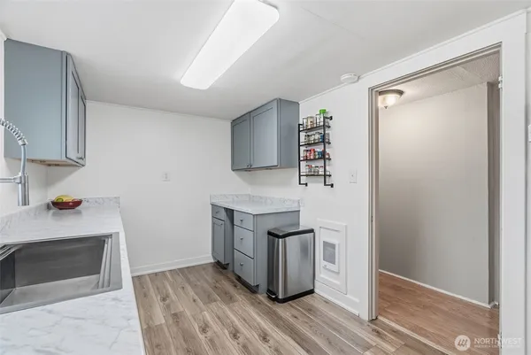 a kitchen with granite countertop a stove and a refrigerator