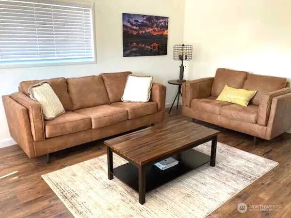 a living room with furniture and a rug