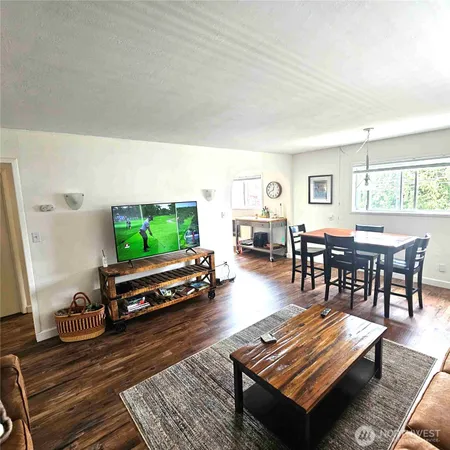 a living room with furniture a flat screen tv and a large window