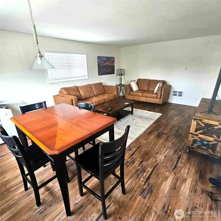 a view of a dining room with furniture and wooden floor