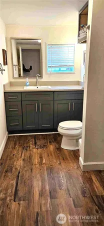 a bathroom with a toilet sink and mirror