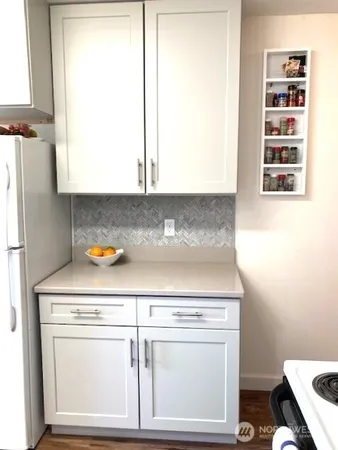 a stove top oven sitting inside of a kitchen