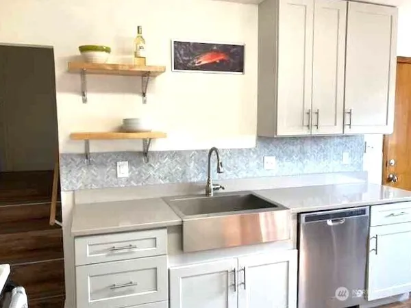 a kitchen with granite countertop a sink and a stove