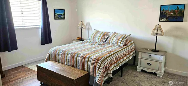 a bedroom with a bed and a night stand