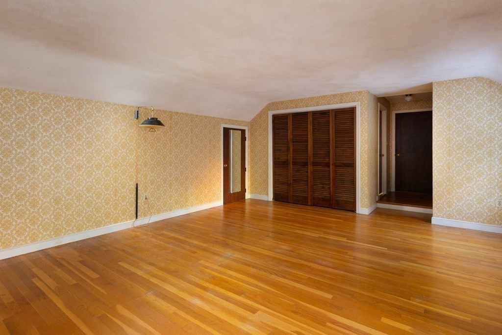 555 Heald Road Carlisle, MA 01741 - Photo 11 of 22 a view of an empty room with wooden floor