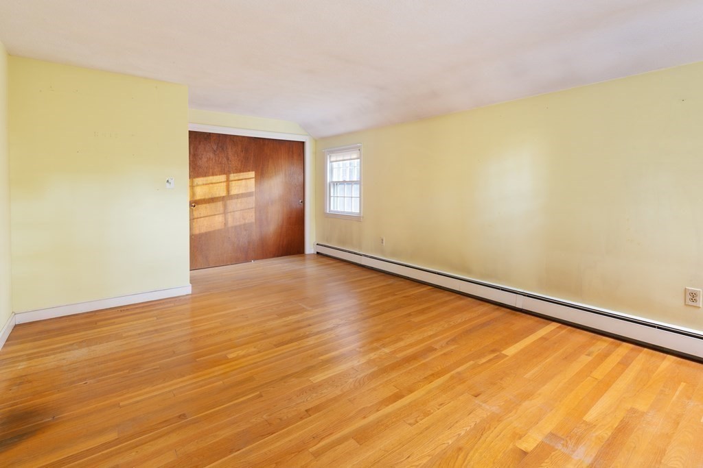 555 Heald Road Carlisle, MA 01741 - Photo 12 of 22 an empty room with wooden floor and windows