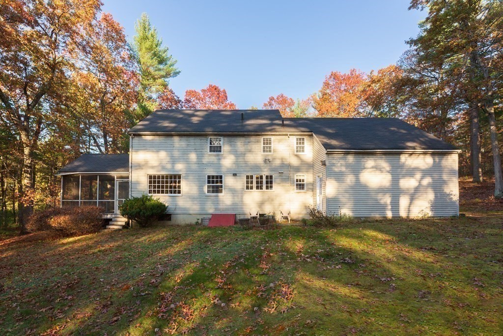 555 Heald Road Carlisle, MA 01741 - Photo 17 of 22 a front view of house with yard and trees around