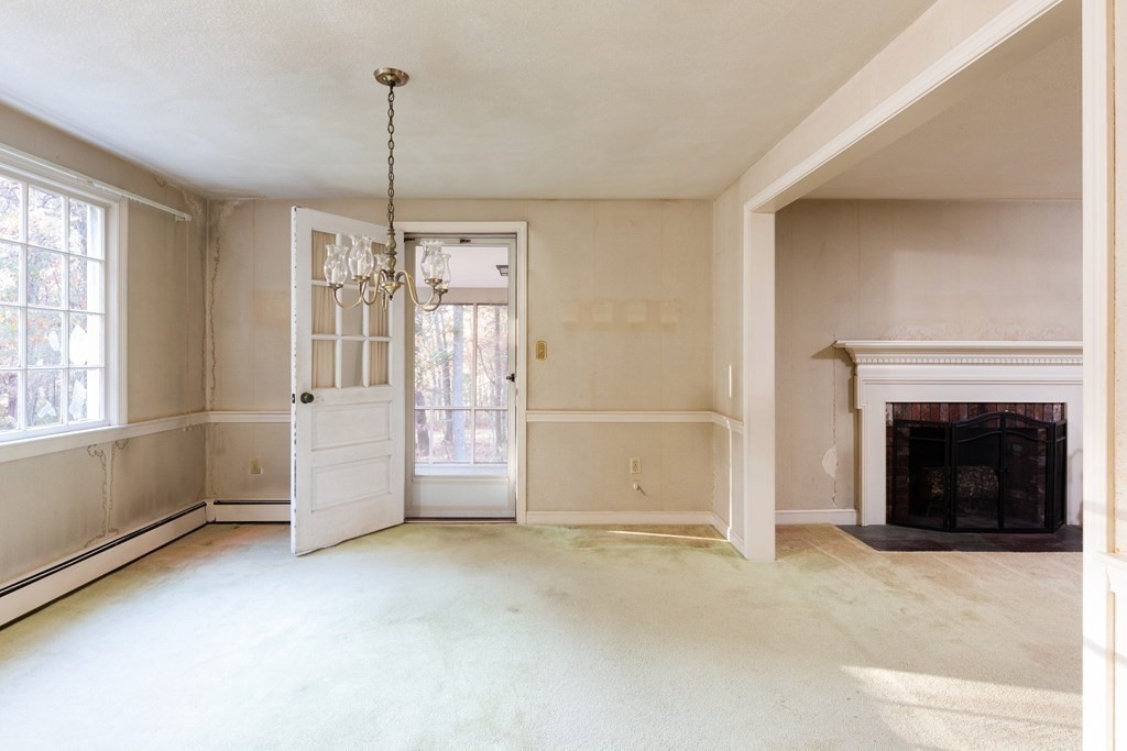 555 Heald Road Carlisle, MA 01741 - Photo 5 of 22 a view of a livingroom with a fireplace and window