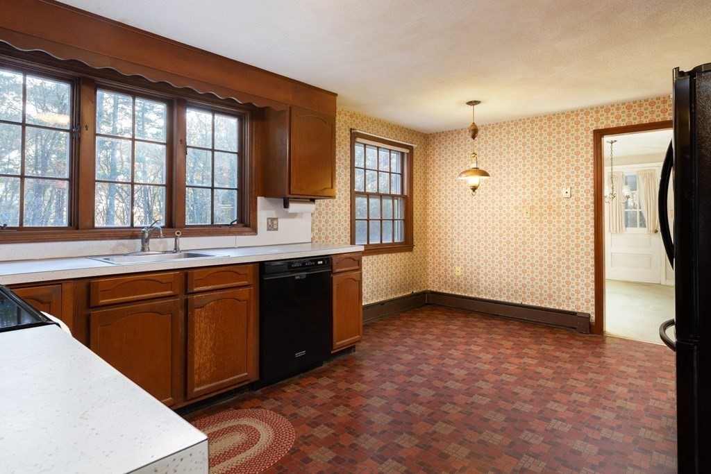 555 Heald Road Carlisle, MA 01741 - Photo 8 of 22 a kitchen with stainless steel appliances granite countertop a sink stove and refrigerator