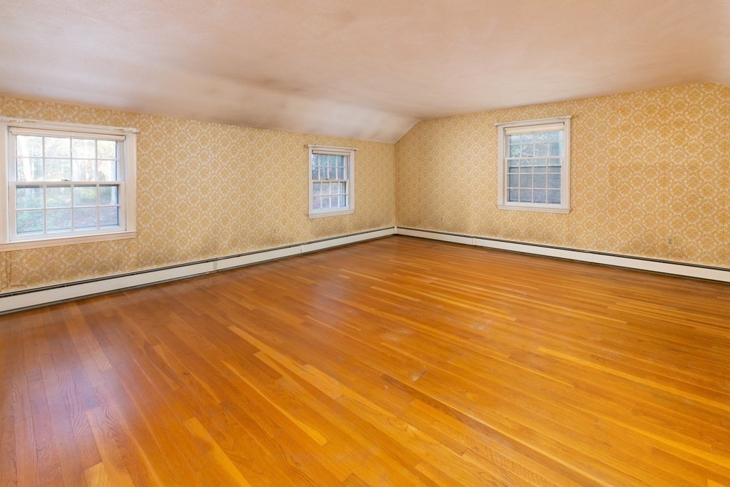 555 Heald Road Carlisle, MA 01741 - Photo 10 of 22 a view of an empty room with wooden floor and a window