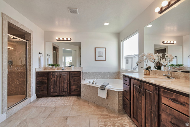 1288 North Horizon View Loop Elk Ridge, UT 84651 - Photo 20 of 40 Bathroom featuring two vanities, a shower stall, and a garden tub