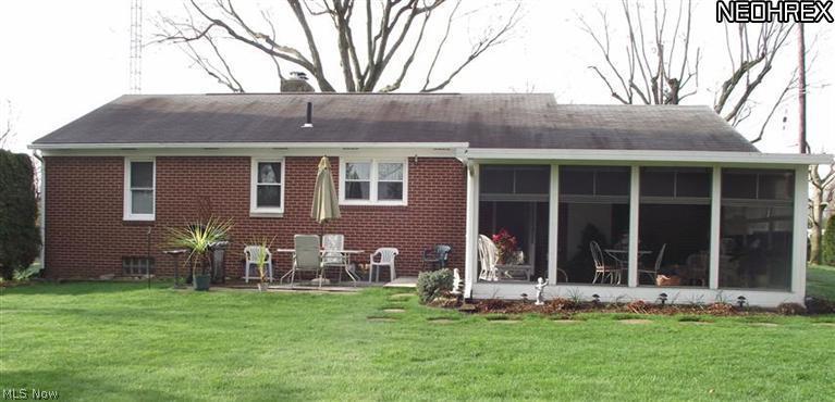 22666 Georgetown Road Homeworth, OH 44634 - Photo 17 of 20 Back of home viewing sunroom and back patio.