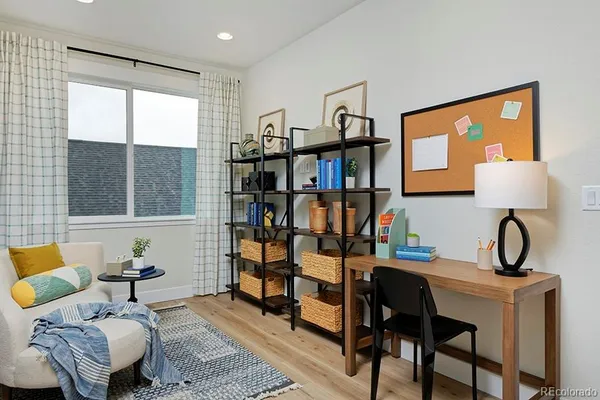 a living room with furniture a window and a painting on the wall