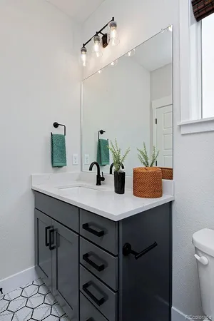 a bathroom with a sink a mirror and vanity