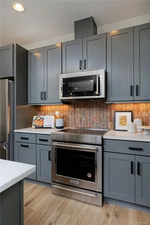 a kitchen with granite countertop a stove and a microwave oven