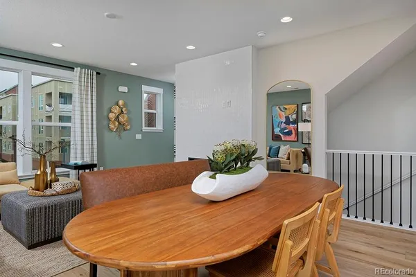 a dining room with furniture and wooden floor