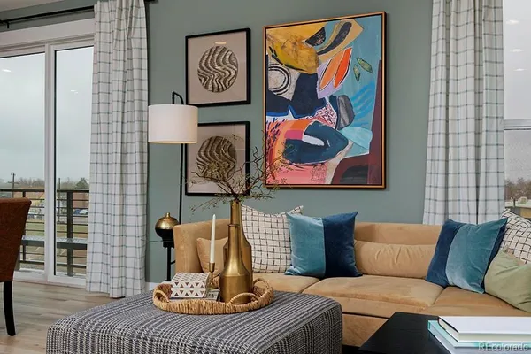 a living room with furniture and painting on the wall