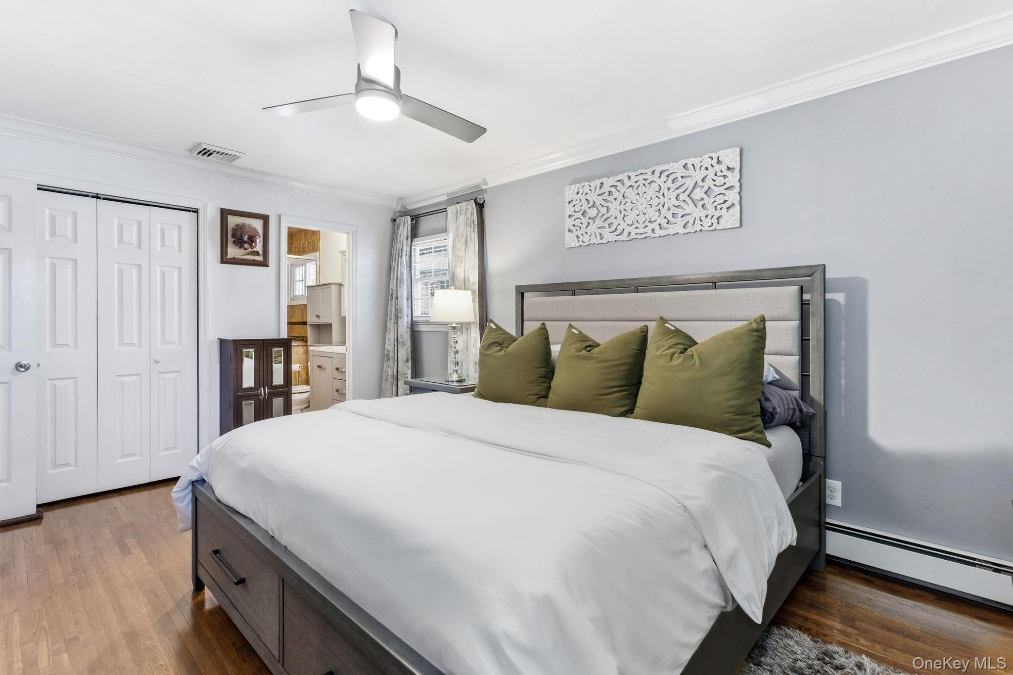 56 Tanager Road Mahopac, NY 10541 - Photo 14 of 30 a large bed in a bedroom next to a window and a chandelier