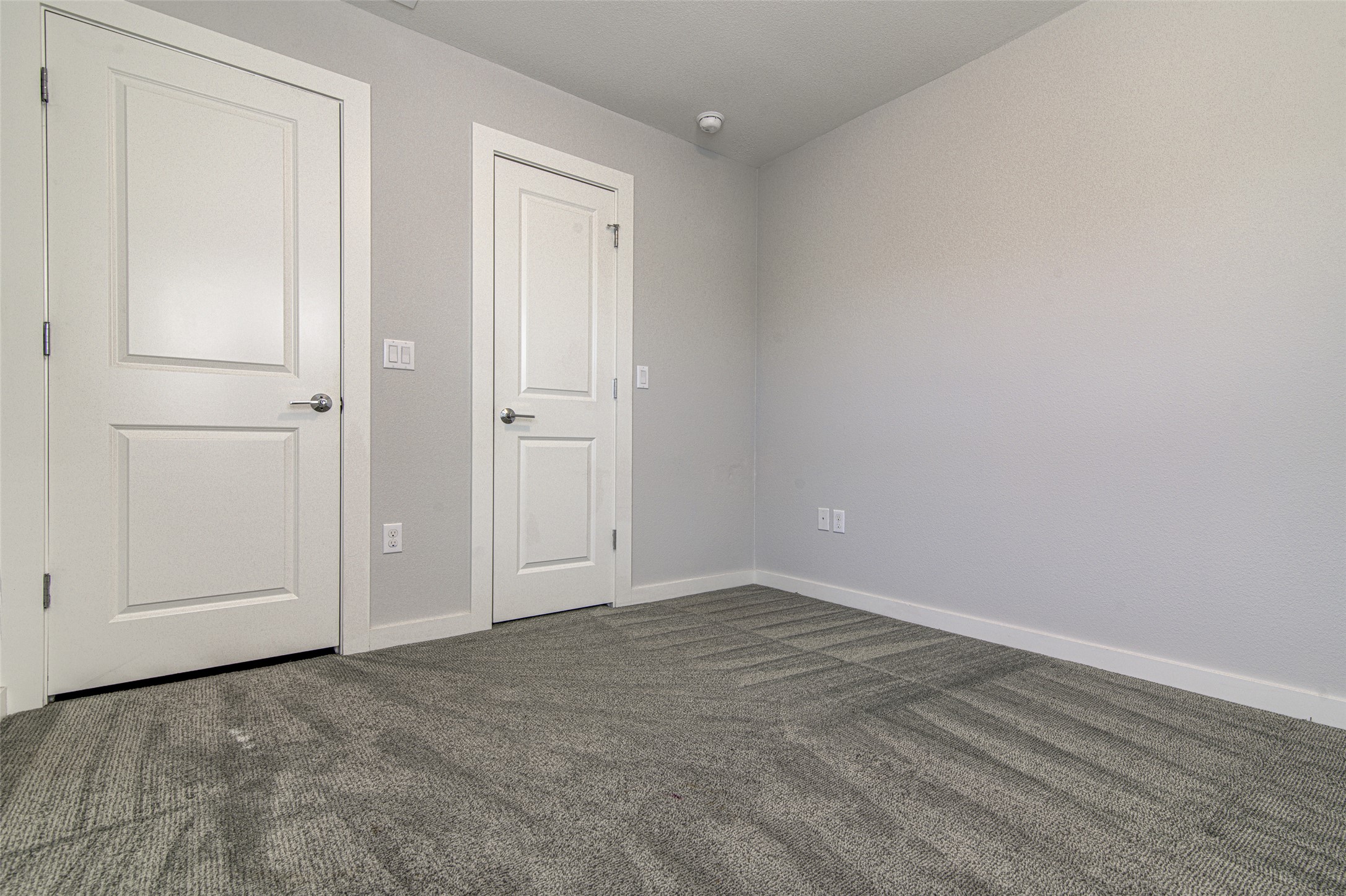 1904 Bunche Road, Unit B Austin, TX 78721 - Photo 17 of 29 Upstairs bedroom with carpeted floors and closet.