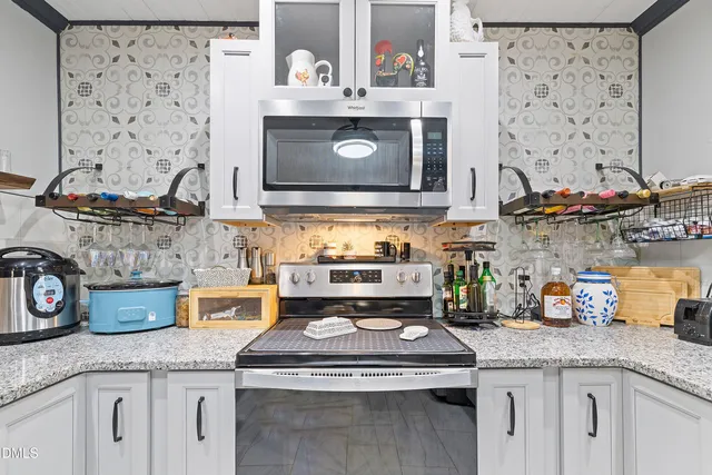 a stove top oven sitting inside of a kitchen