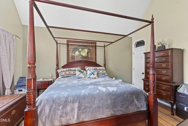 a bedroom with a bed and a dresser