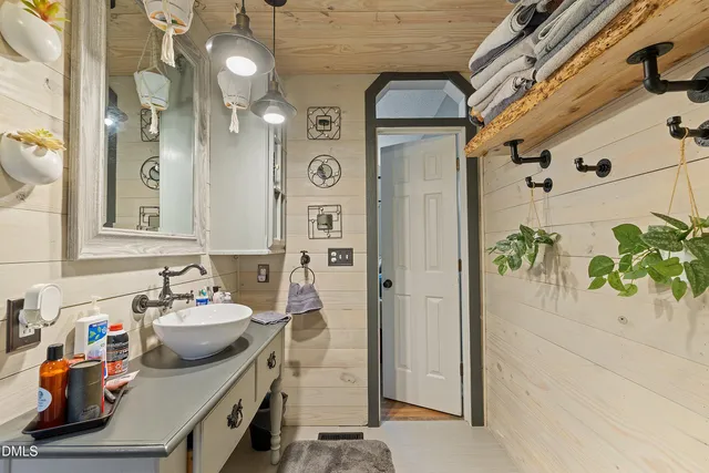 a bathroom with a sink mirror and shower