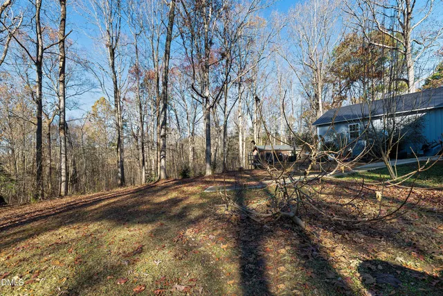 a view of a yard with wooden fence