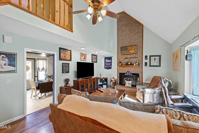 a living room with furniture a flat screen tv and a window