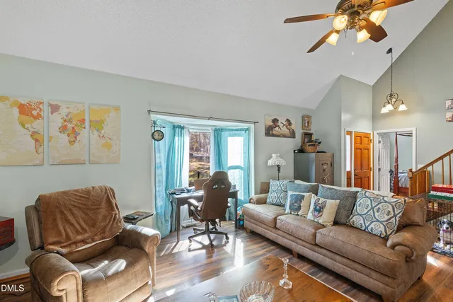 a living room with furniture and wooden floor