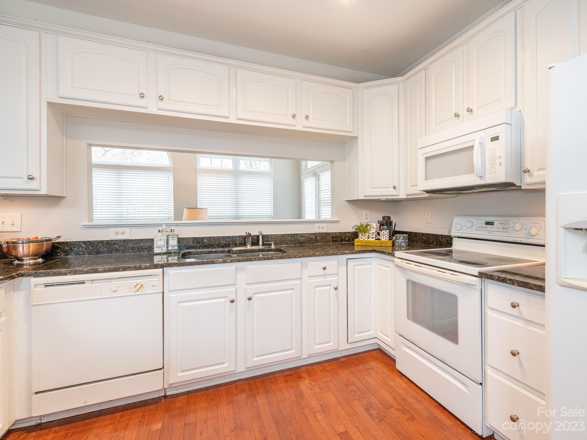 3764 Leela Palace Way Fort Mill, SC 29708 - Photo 11 of 32 a kitchen with granite countertop white cabinets and white appliances