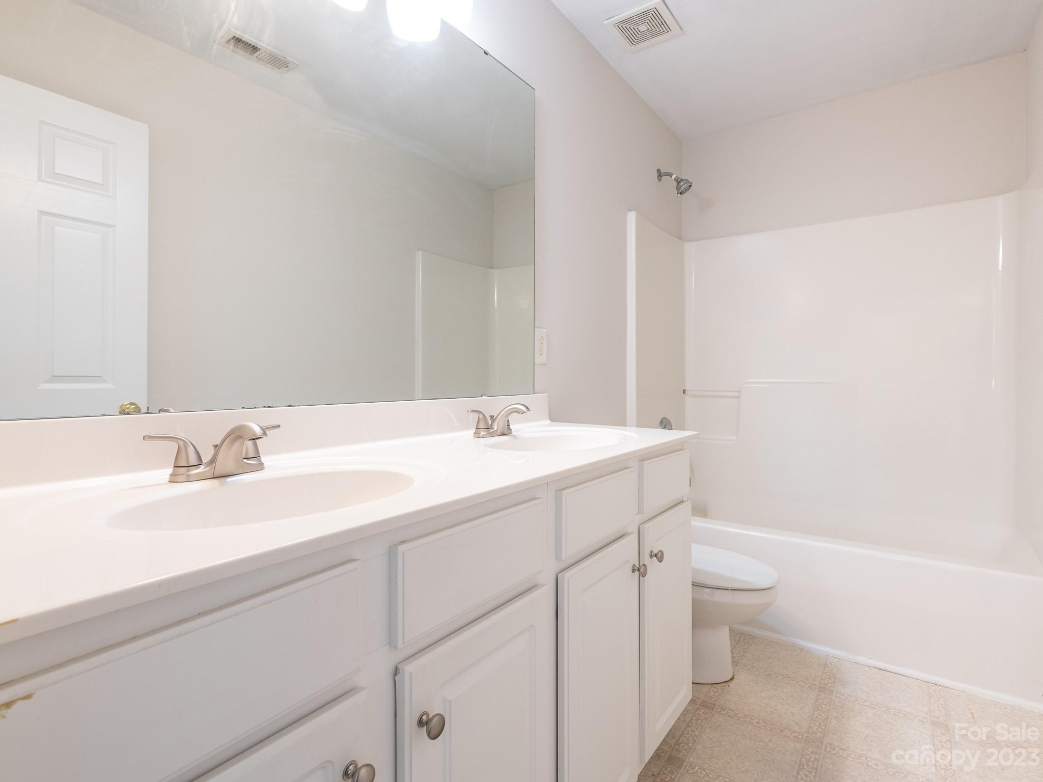 3764 Leela Palace Way Fort Mill, SC 29708 - Photo 23 of 32 a bathroom with a granite countertop sink a toilet and a bathtub