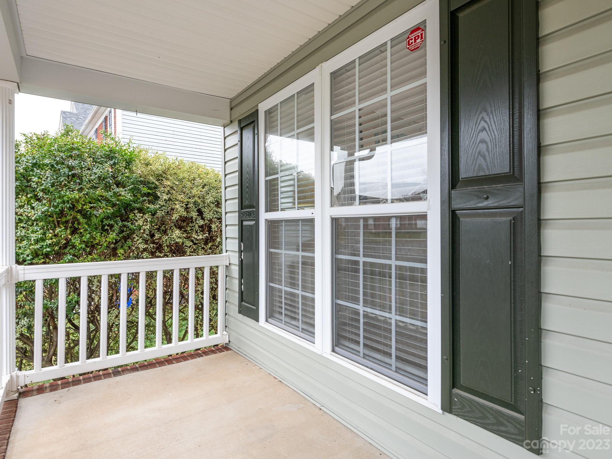 3764 Leela Palace Way Fort Mill, SC 29708 - Photo 3 of 32 a view of porch with a floor to ceiling window and wooden fence