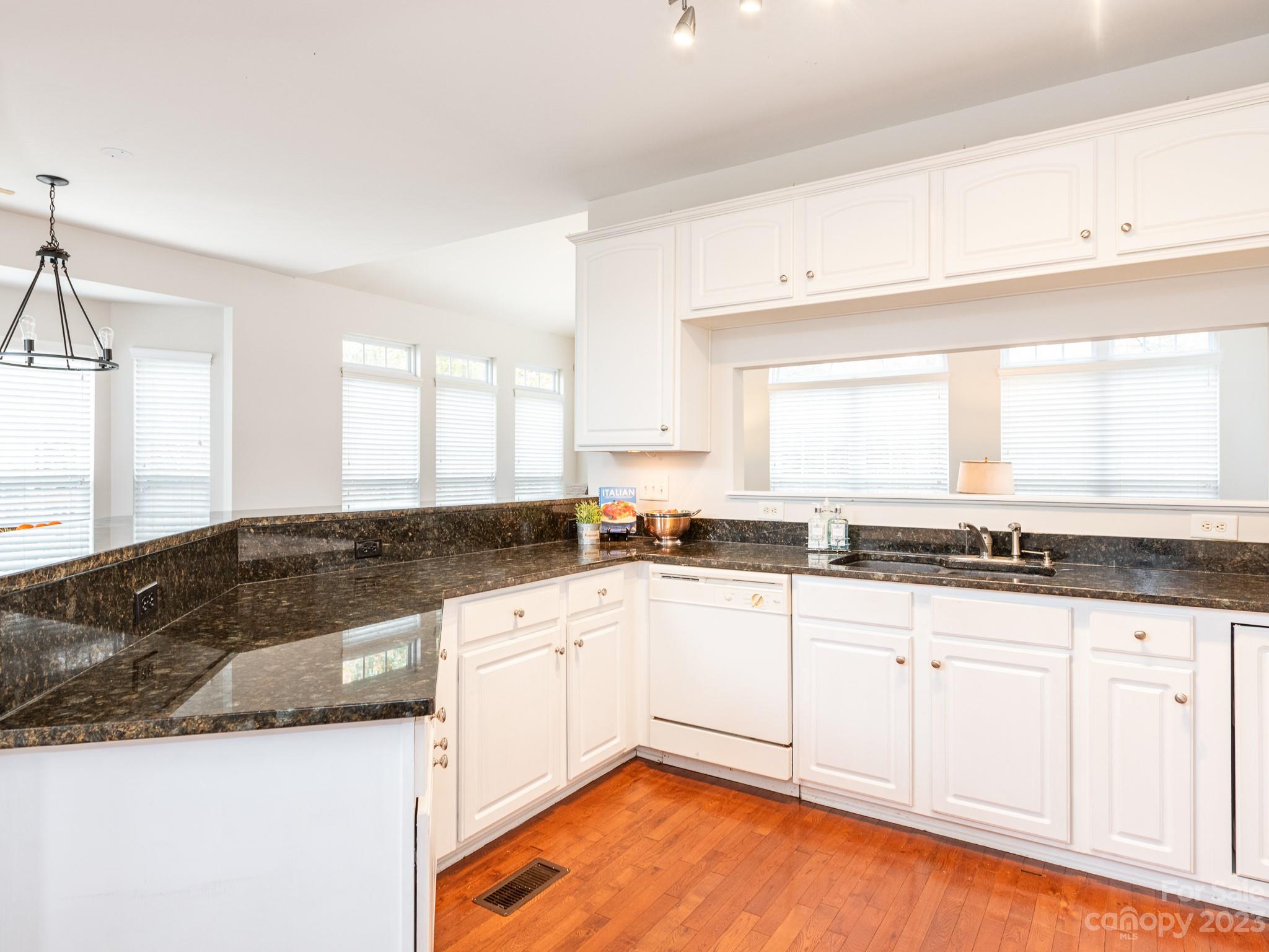 3764 Leela Palace Way Fort Mill, SC 29708 - Photo 10 of 32 a large kitchen with granite countertop a sink a stove and cabinets