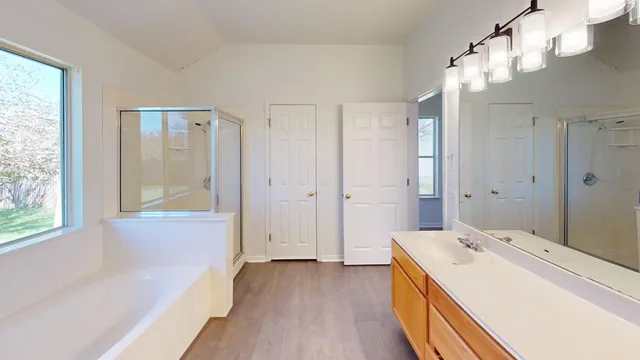 a view of a bathroom with tub shower and window