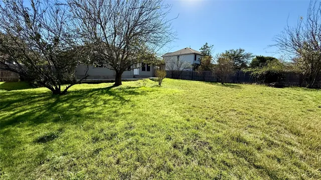 a backyard of a house with lots of green space