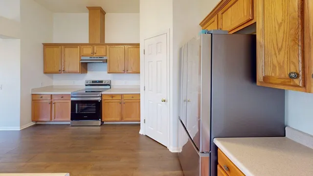 a kitchen with stainless steel appliances a stove a sink and a refrigerator